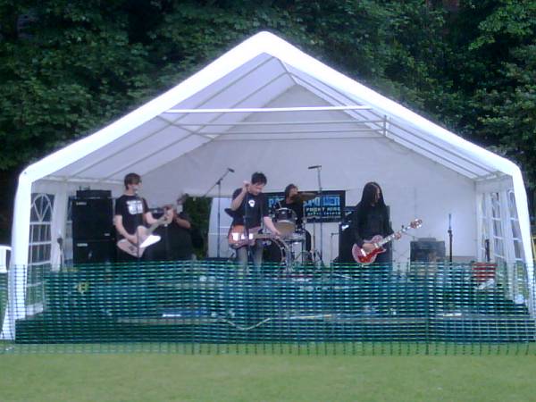 band on stage under cover